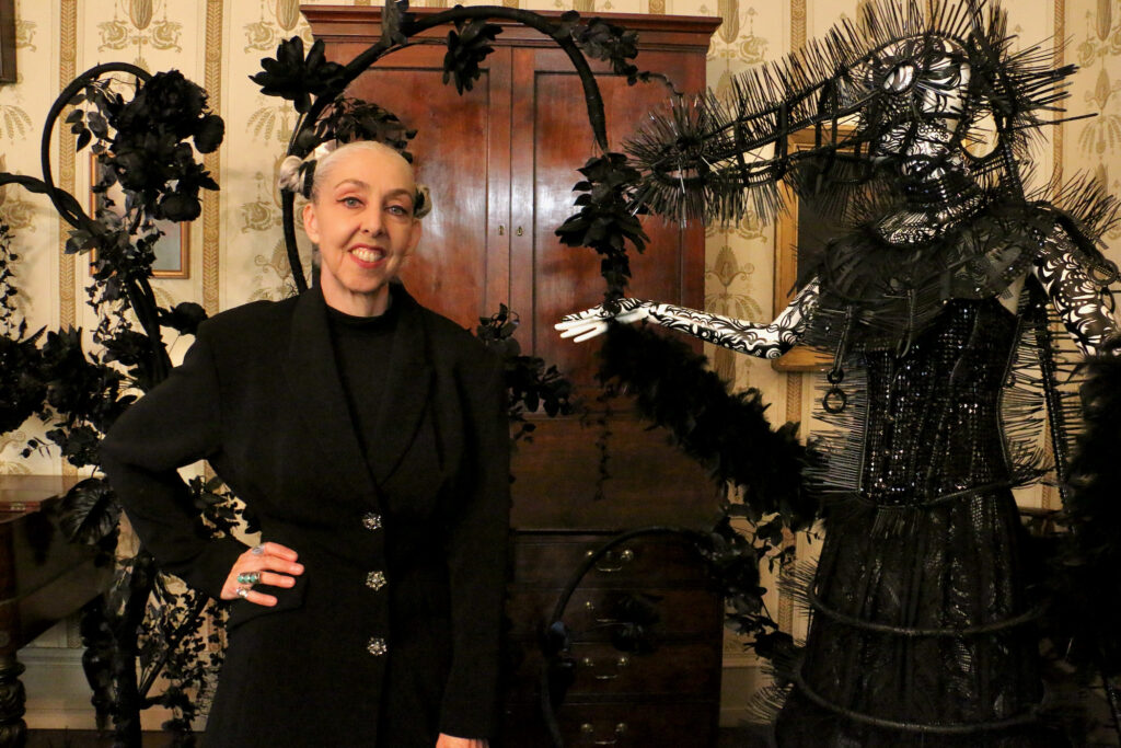 2023 11 28-e lee-heather ujiie-philadelphia physick house-dark forest hoop skirt Heather Ujie stands next to a sculpture