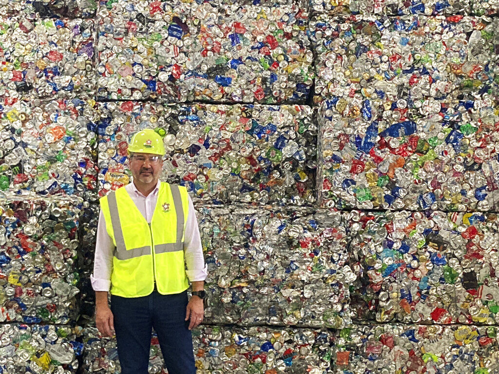 Recycling – Where does it all go? Pete Keller, vice president of sustainability for Republic Resources poses for a photo at a facility in Oberlin, Ohio, in front of cubes of compressed plastic bottles