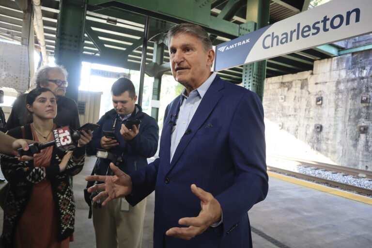 West Virginia Democratic Sen. Joe Manchin speaks with reporters outside the newly renovated Amtrak train station in Charleston, W.Va. on Thursday, Oct. 12, 2023 (