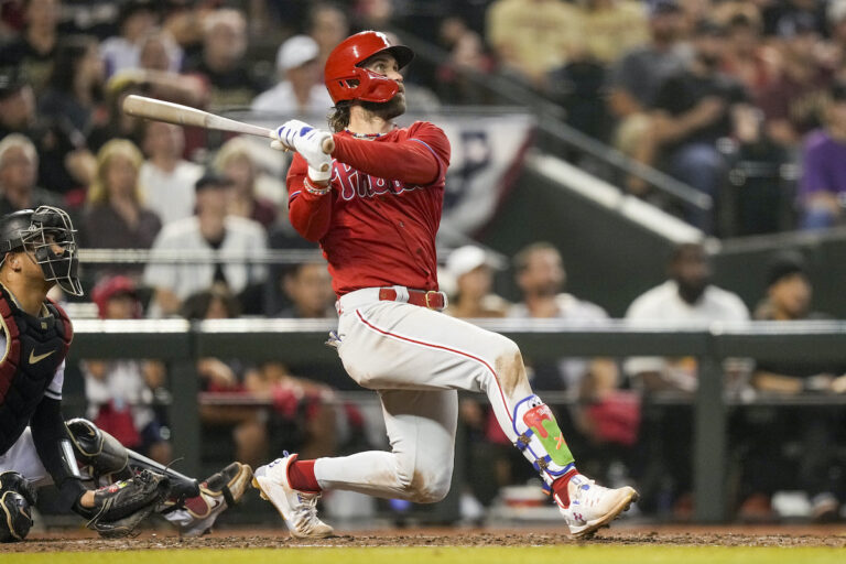 Philadelphia Phillies' Bryce Harper watches his home run against the Arizona Diamondbacks during the sixth inning in Game 5 of the baseball NL Championship Series in Phoenix, Saturday, Oct. 21, 2023.
