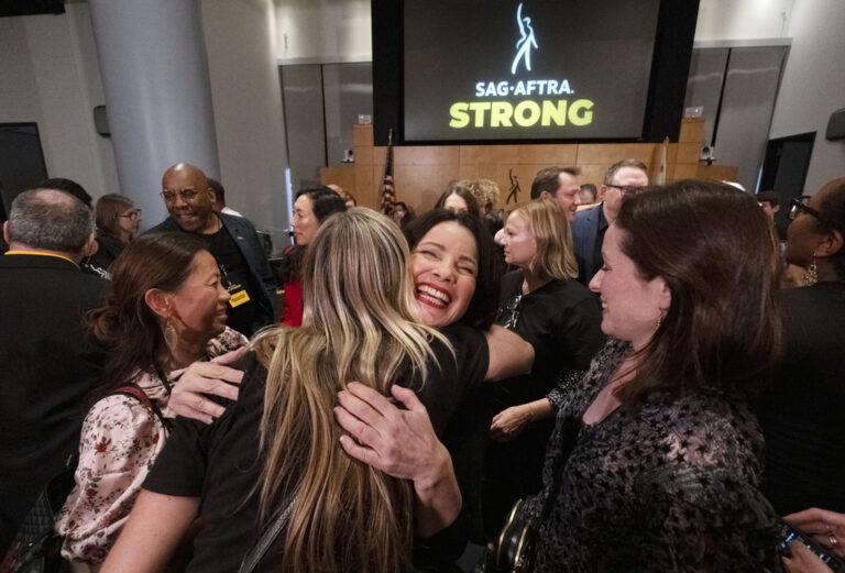 SAG-AFTRA President Fran Drescher, hugs a member of the TV/Theatrical Negotiating Committee member