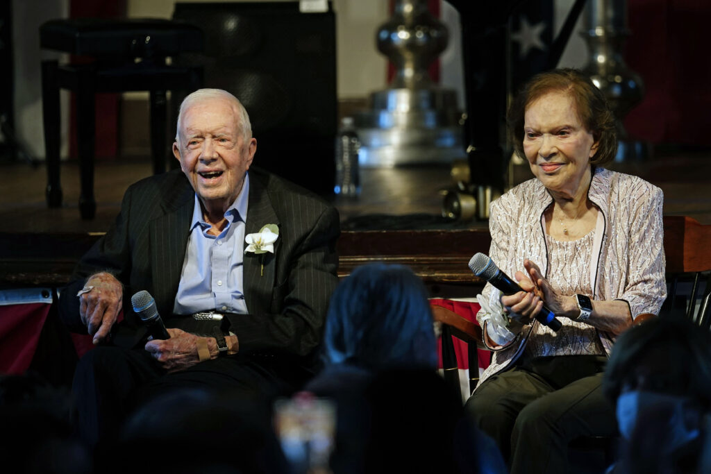 Former U.S. President Jimmy Carter and his wife, former first lady Rosalynn Carter, sit together during a reception to celebrate their 75th wedding anniversary, July 10, 2021, in Plains, Ga.