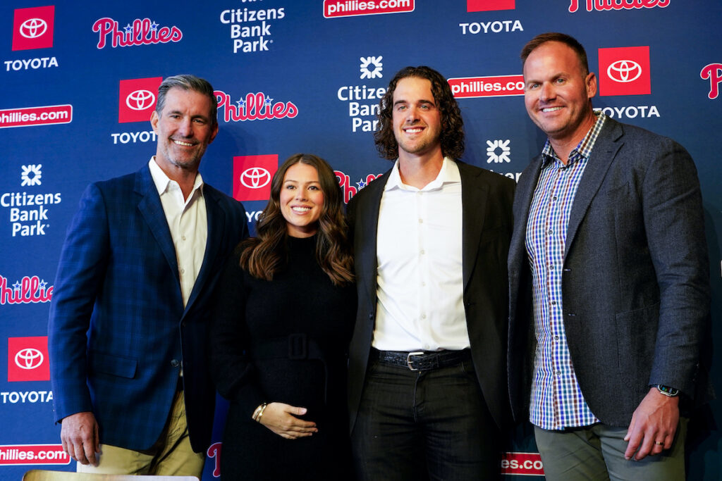 Philadelphia Phillies' Aaron Nola (center right) pose for a photo after signing a seven year contract with his agents Joseph C. Longo (left) and Garrett Parcell (right) and his wife Hunter Jayde Harrington (center left) Monday, Nov. 20, 2023, in Philadelphia.