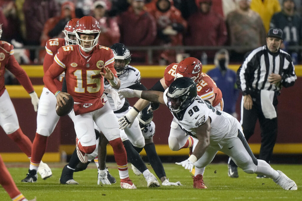 Eagles Chiefs Football Kansas City Chiefs quarterback Patrick Mahomes (15) scrambles as Philadelphia Eagles defensive tackle Jalen Carter (98) defends during the first half of an NFL football game, Monday, Nov. 20, 2023, in Kansas City, Mo