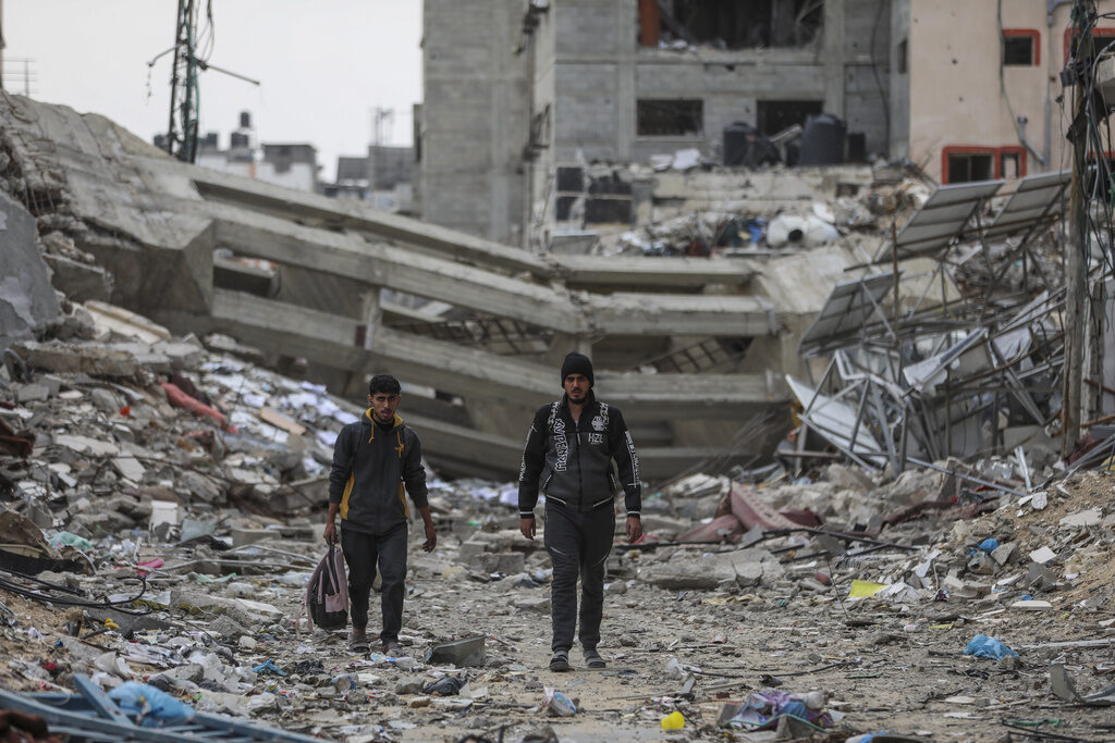 Israel Palestinians Palestinians walk through destruction in Shati refugee camp