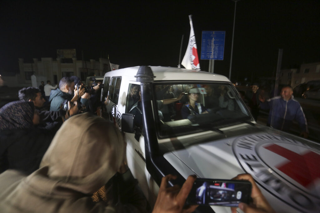 Israel Palestinians A Red Cross vehicle passes through a crowd of people.