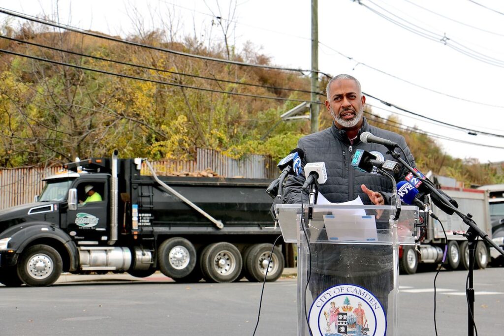 Camden Mayor Vic Carstarphen stands before an enormous mound dirt and debris at 7th and Chestnut streets while announcing the final phase of the cleanup of the illegal dump..