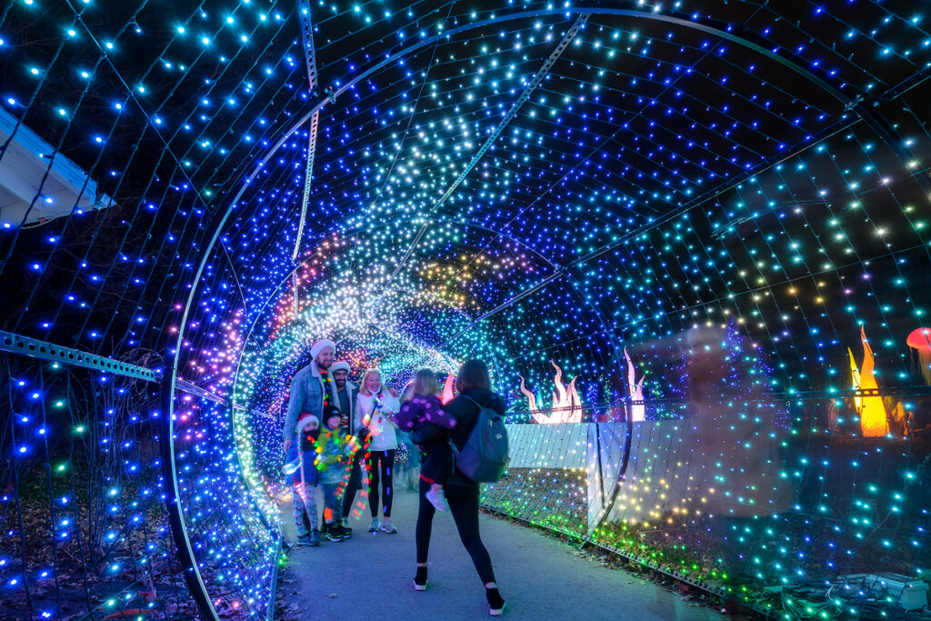 People walk through a light tunnel