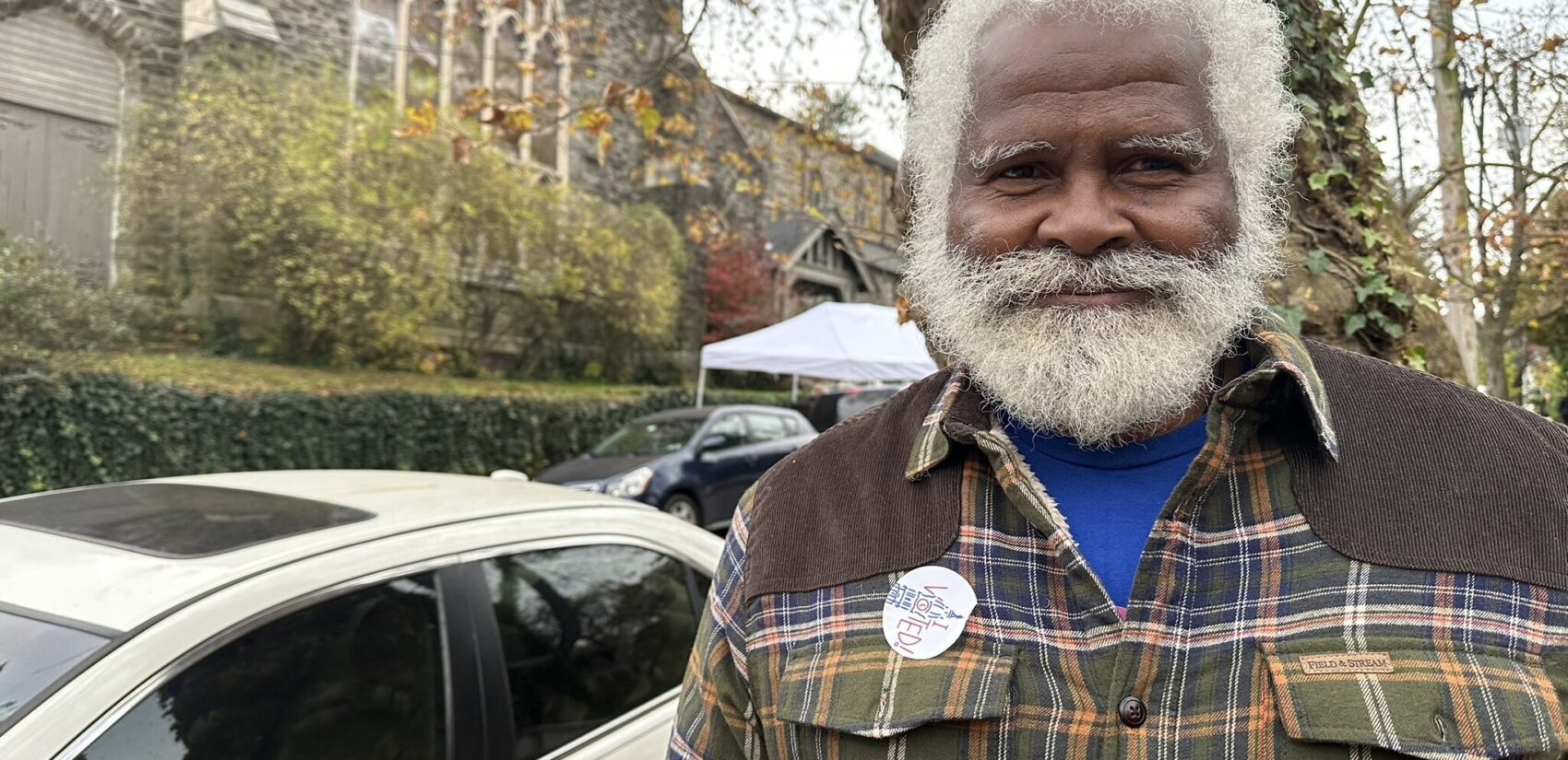 A Philadelphia voter poses for a photo outside their polling place