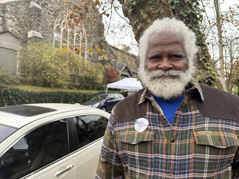 A Philadelphia voter poses for a photo outside their polling place