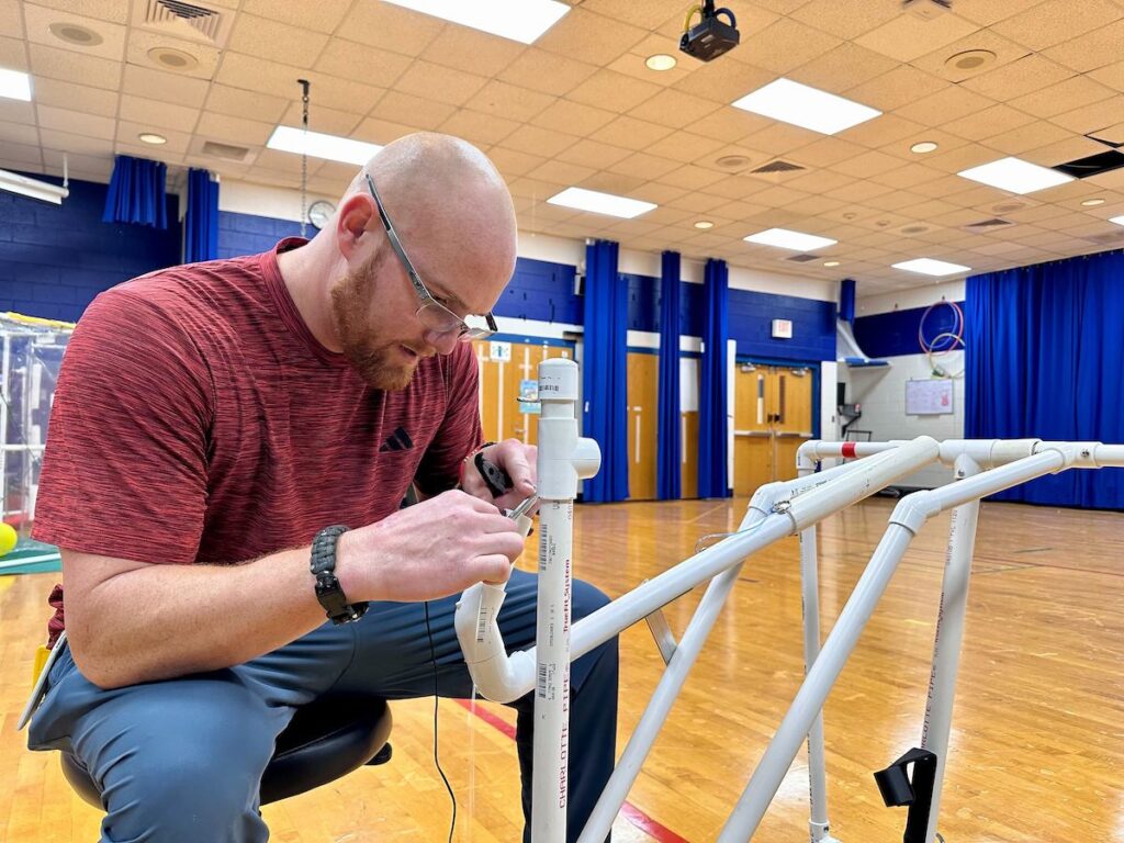 adaptive-play-equipment-2 Frank Hughes fixes a piece of adaptive play equipment