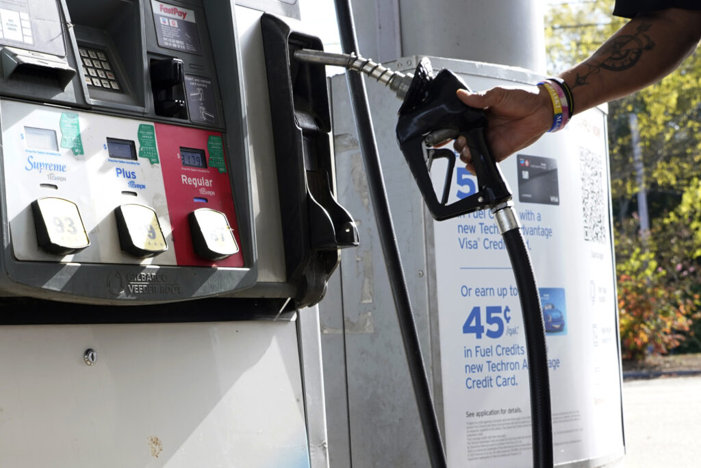 A customer replaces the pump dispenser at a Chevron gas station in Columbus, Miss., on Oct. 23. The average price of regular gas has fallen more than 40 cents from a year ago. A customer replaces the pump dispenser at a Chevron gas station in Columbus, Miss., on Oct. 23. The average price of regular gas has fallen more than 40 cents from a year ago.