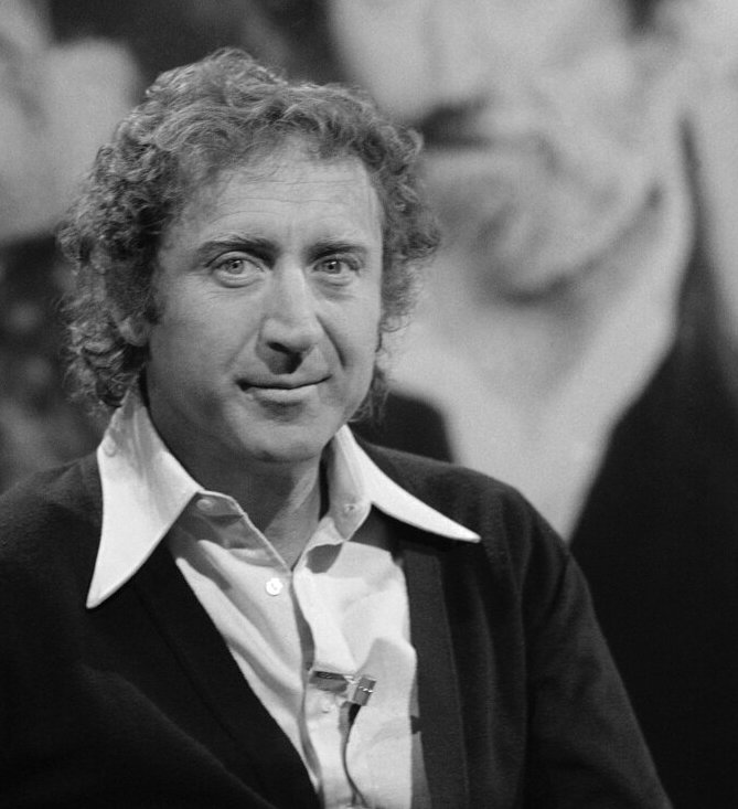 A black-and-white image of Gene Wilder posing for a photo.