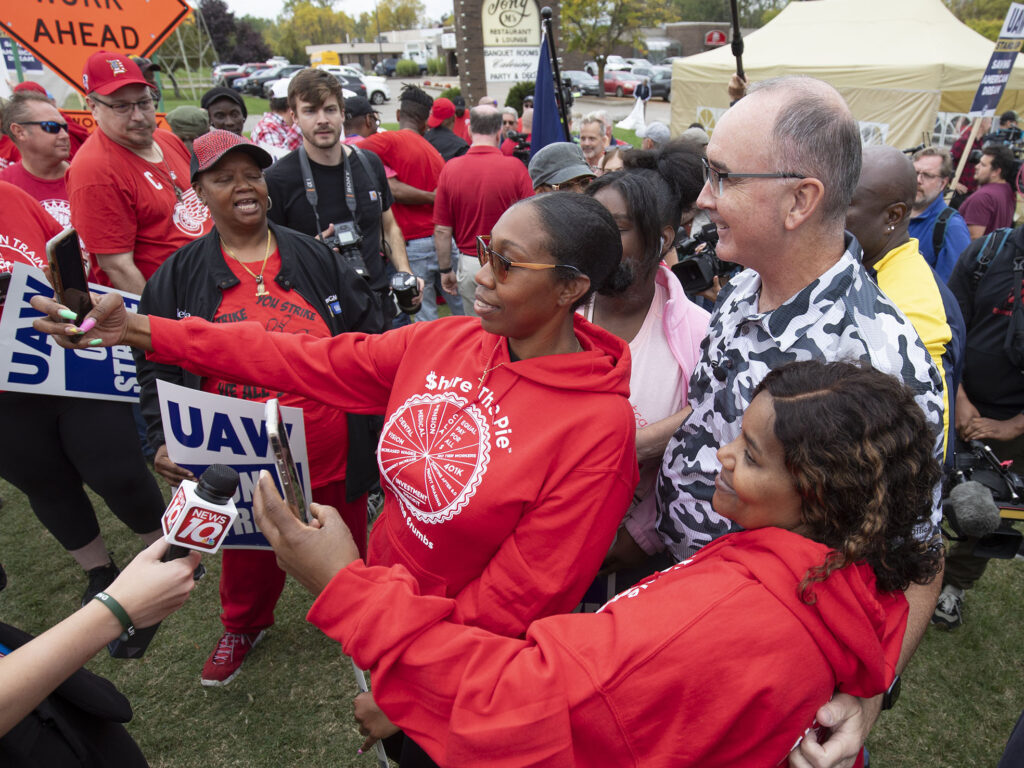 United Auto Workers President Shawn Fain posed with UAW members as they strike the General Motors Lansing Delta Assembly Plant in Michigan in late September. United Auto Workers President Shawn Fain posed with UAW members as they strike the General Motors Lansing Delta Assembly Plant in Michigan in late September.