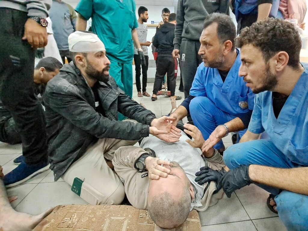 PALESTINIAN-ISRAEL-CONFLICT Palestinian medics listen to a man as the wounded are brought to the Kamal Adwan hospital in Beit Lahia in Gaza following Israeli bombardment on Tuesday. The hospital is situated just a few miles south of the Indonesian hospital, which was hit Monday by Israeli shelling, according to Palestinian officials. AFP via Getty Images