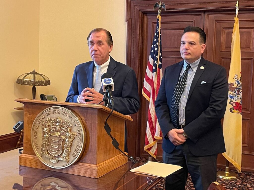 N.J. Assembly Speaker Craig Coughlin (left) and state Senate President Nick Scutari (right) speak at a podium