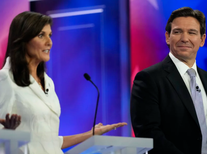 republican-debate-miami-04 Republican presidential candidate former U.N. Ambassador Nikki Haley speaks as Florida Gov. Ron DeSantis listens during a Republican presidential primary debate hosted by NBC News on Wednesday in Miami.
