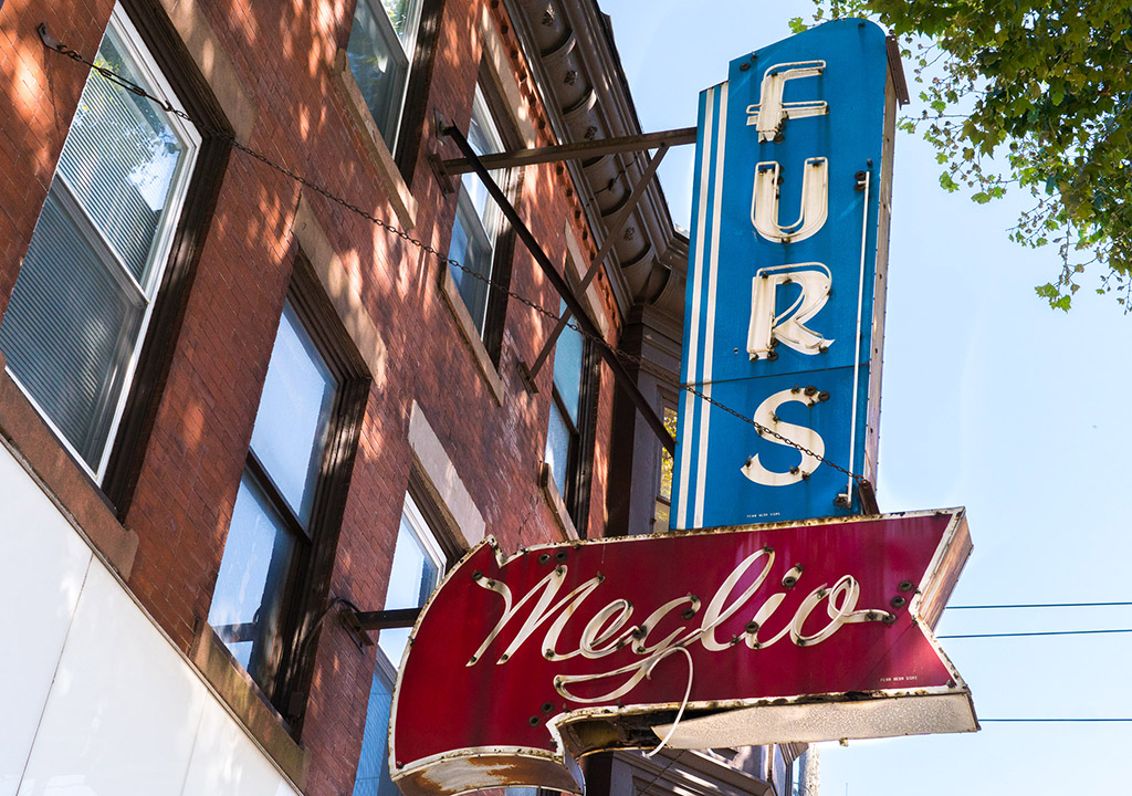 southbroad-credit-danyahenninger-meglio A sign reading Meglio Furs hangs from the side of a building in South Philly