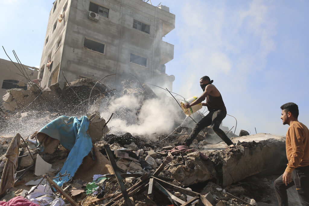 Israel Palestinians Palestinians extinguish the fire after an Israeli airstrike