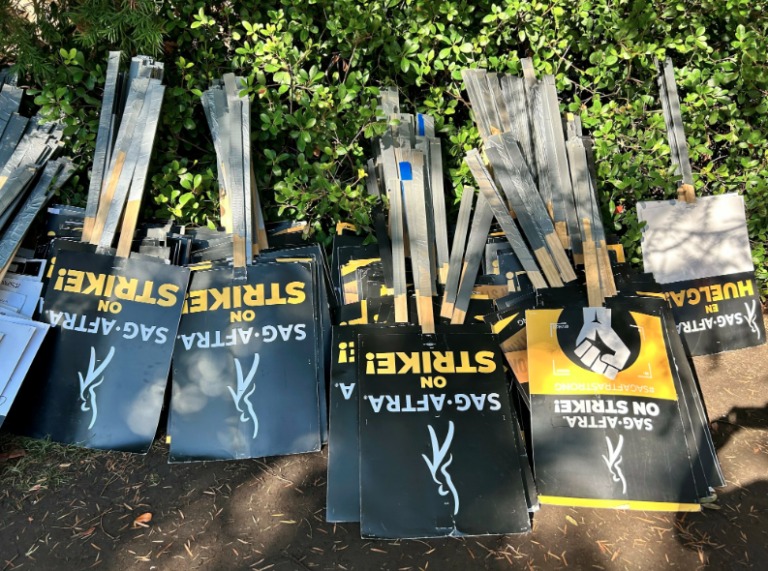 SAG-AFTRA strike signs are seen upside down