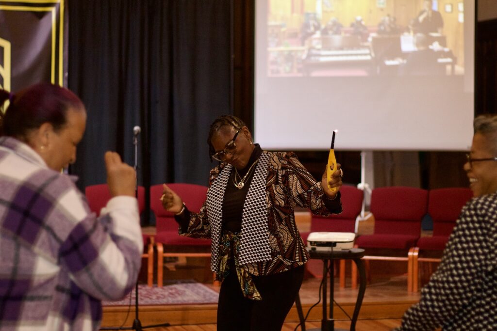 Jeannine Osayande dances with her neighbors