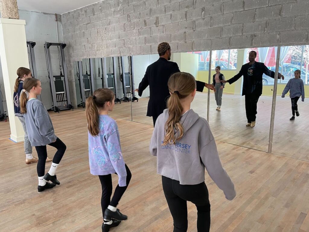 tap-dance-2 Kids face towards their teachers as the teacher demonstrates a certain tap dance step
