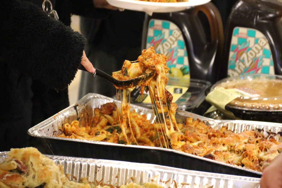 transgiving-2 A person lifts a spoonful of baked ziti out of a pan