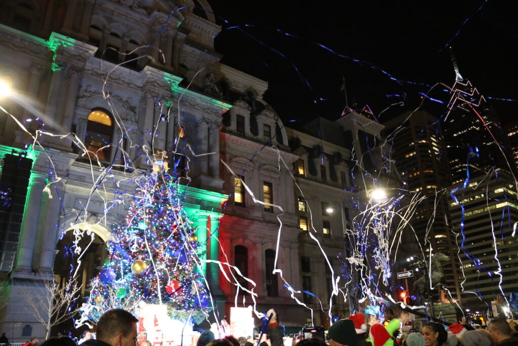 tree-lighting-11 Confetti flies through the air. In the background is Philadelphia's holiday tree and City Hall
