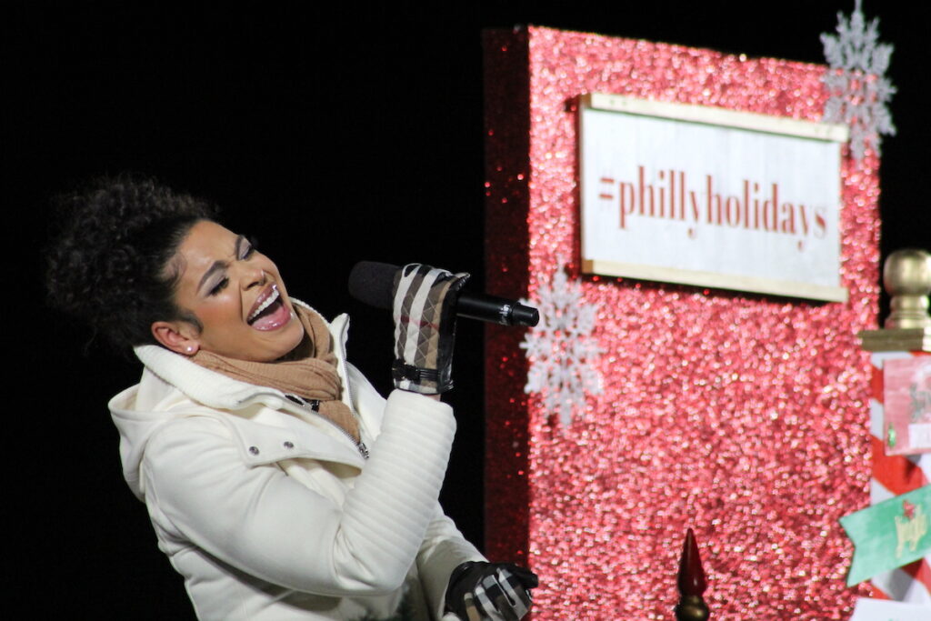 Jordin Sparks sings into a microphone