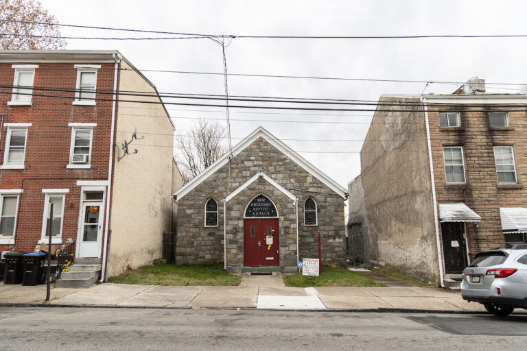 A former church is visible between rowhomes