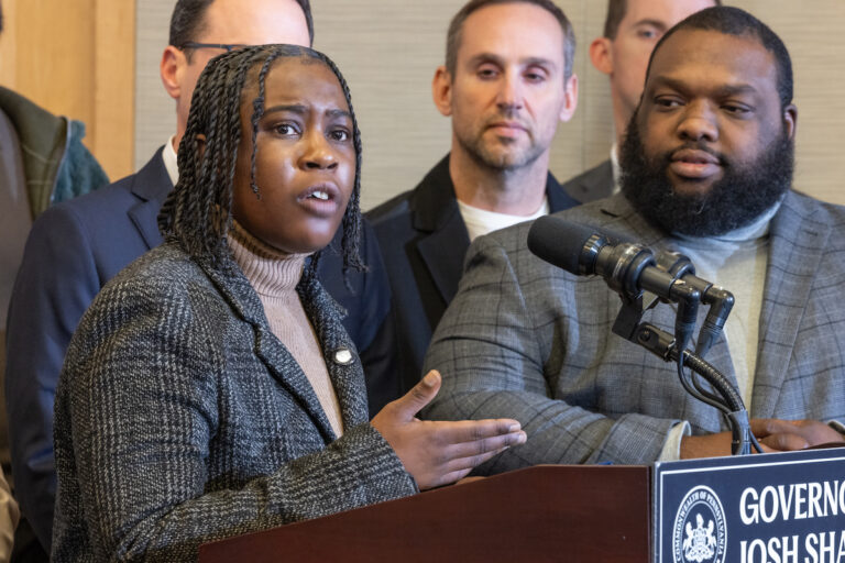 LaTonya Myers speaks at the podium