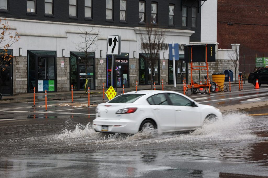 12 18 2023 kpaynter dekaware river flooding post storm-6 Cars drove through standing water onto Spring Garden Street in Philadelphia after a storm brought heavy rain to the region and the Delaware River overflowed onto the road on December 18, 2023. (Kimberly Paynter/WHYY)