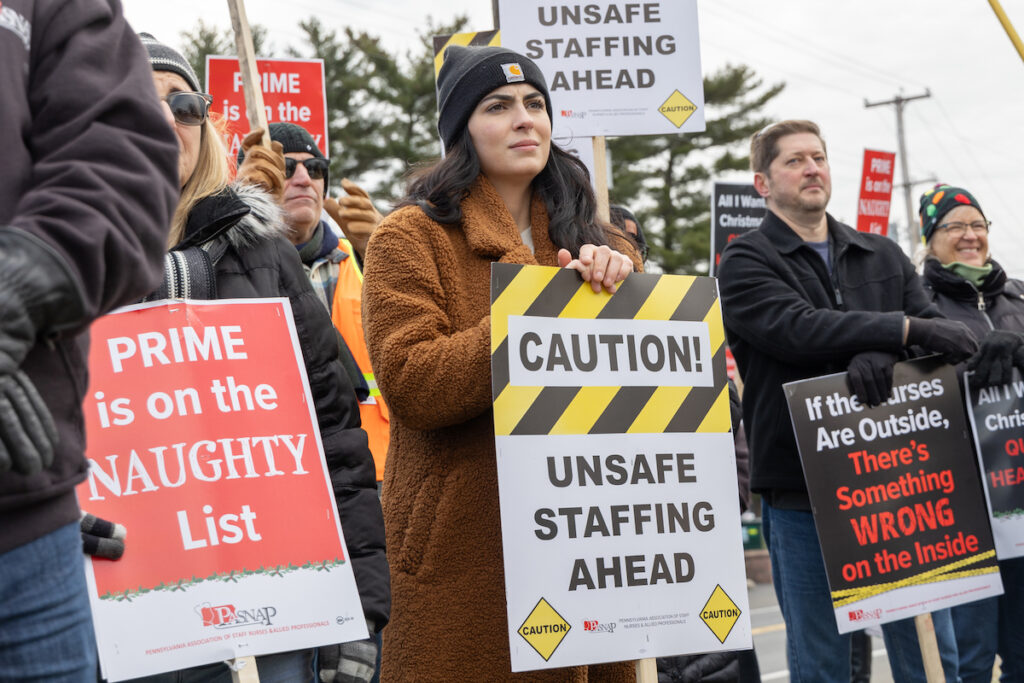 12 22 2023 k paynter lower bucks hospital maria valletto Maria Valleto holds a sign that reads