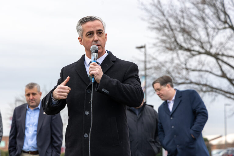 Bucks County Commissioner Robert Harvie speaks into a microphone
