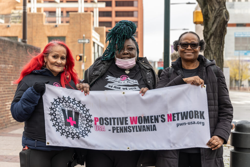 12 4 2023 k paynter PWN members protest safehouse vs. U.S Maria Cookie Cruz (left), Kenya Moussa (center) co-chairs of PWN Pennsylvania, with Jeanette Murdock a PWN member who canvassed for overdose prevention centers in Philadelphia, outside the federal courthouse in Philadelphia on December 4, 2023. (Kimberly Paynter/WHYY)