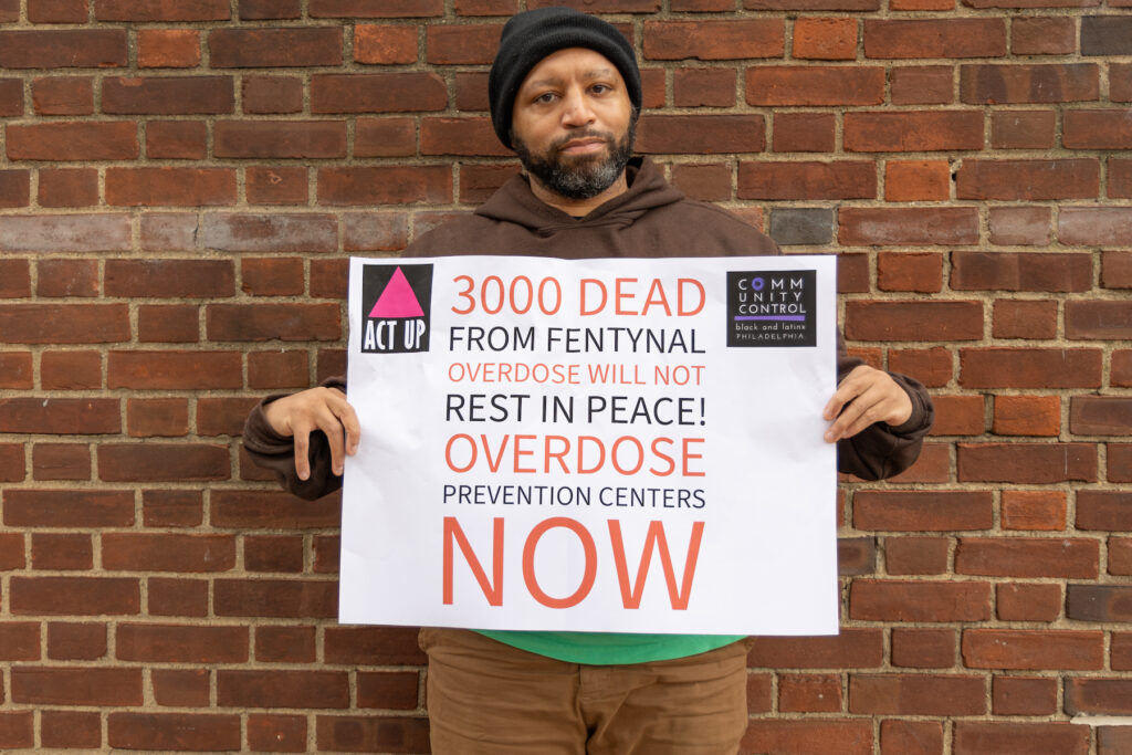 Sterling Johnson holding a sign at a protest