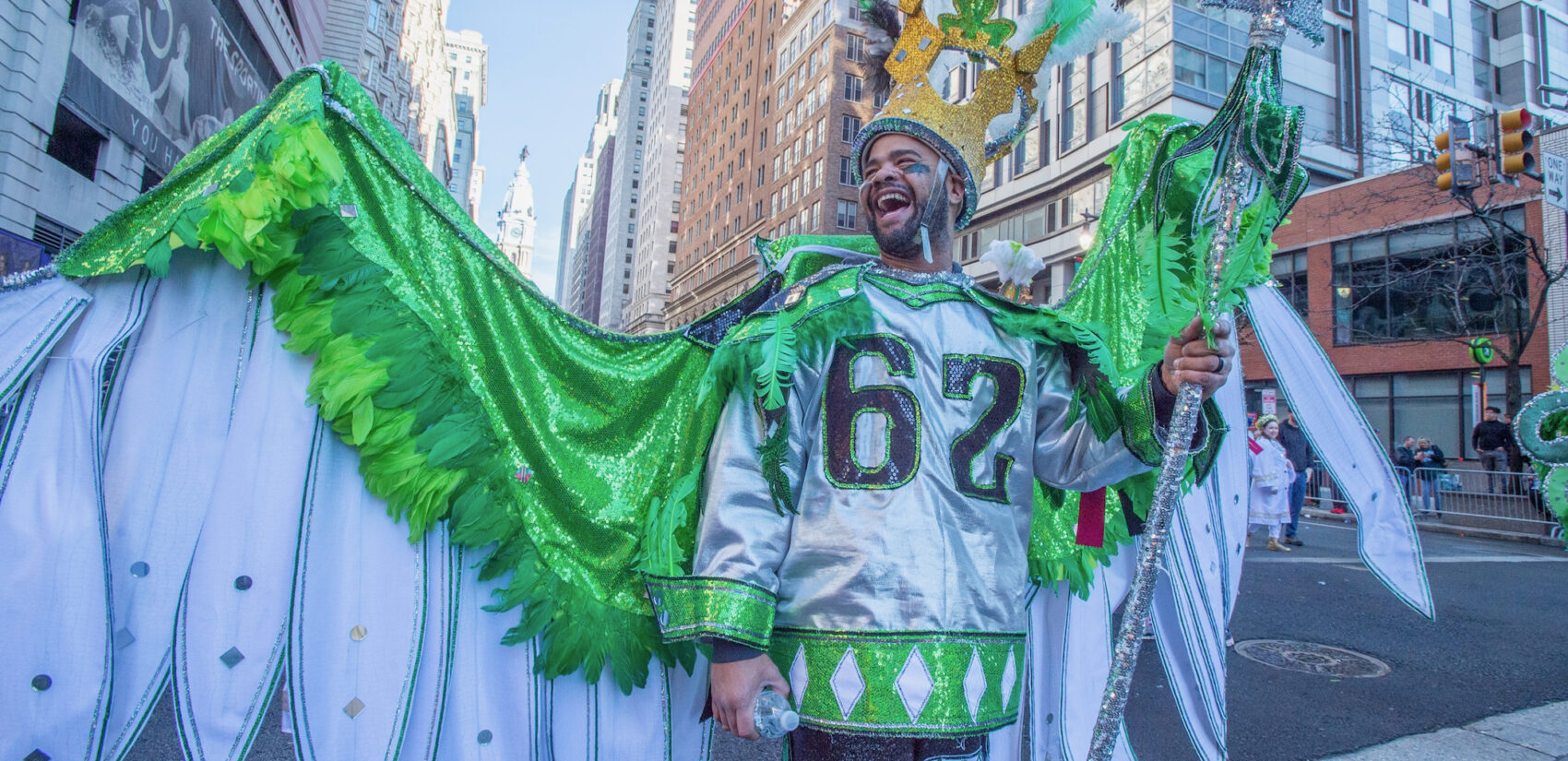 A man in full Mummers costume is wearing a Jason Kelce jersey
