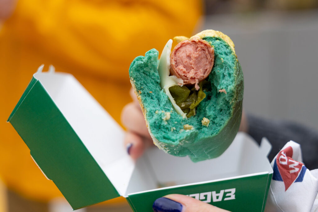 Hot dog on a green-colored bun