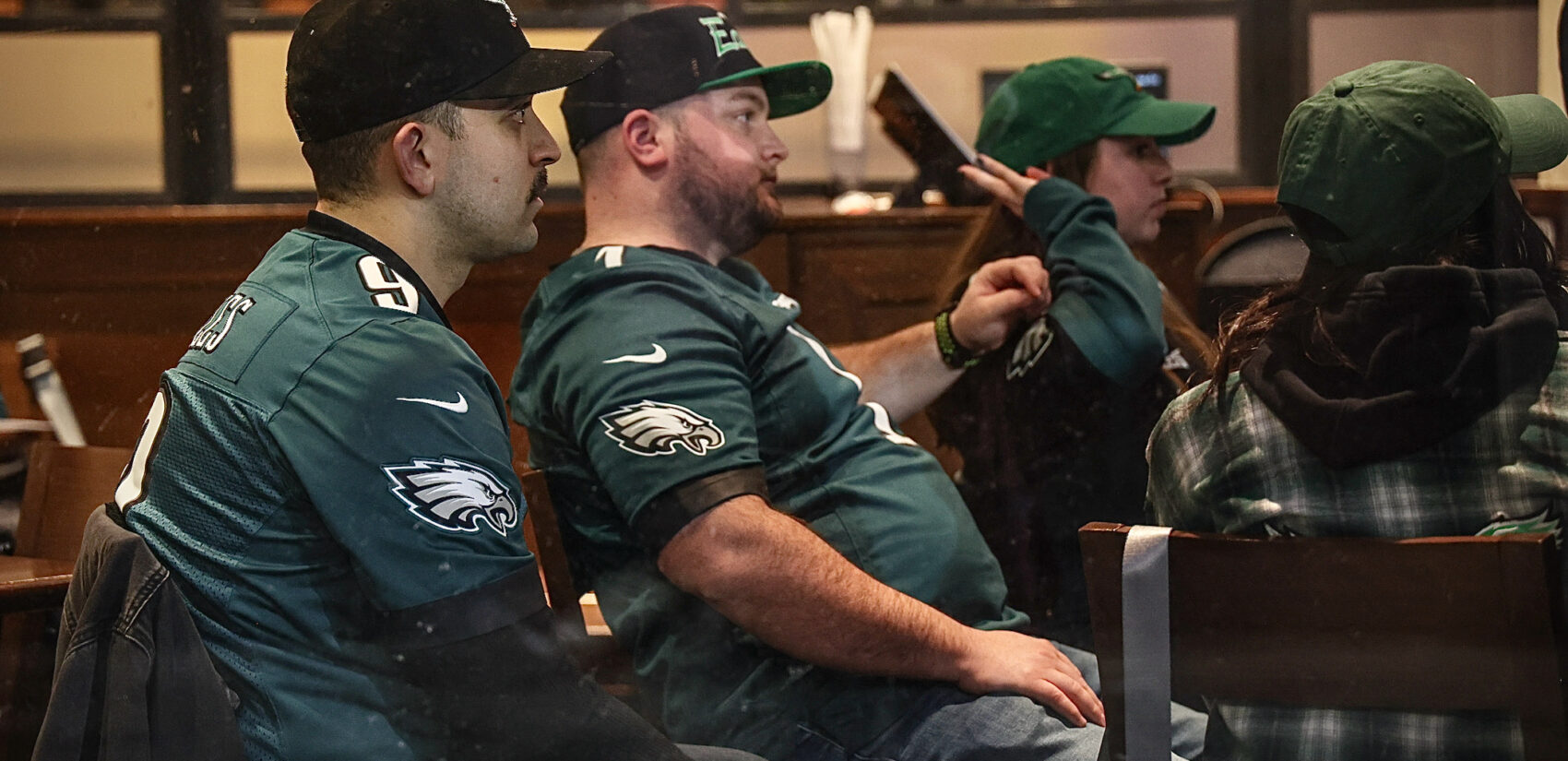 Dejected Eagles fans watch the Super Bowl at a bar.