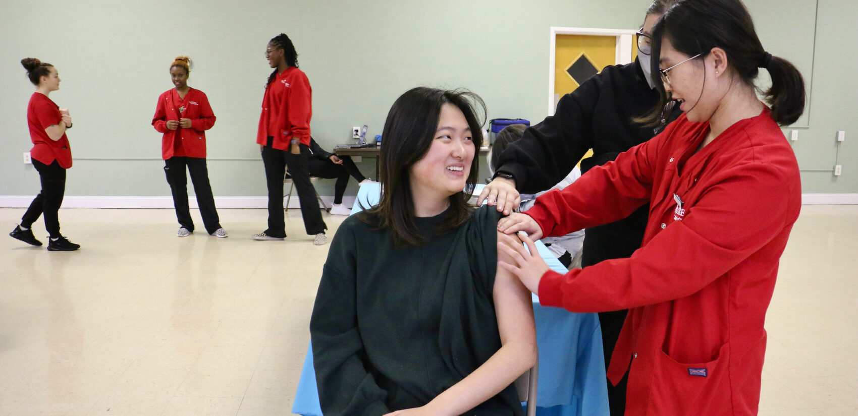 A woman receiving a COVID booster shot.