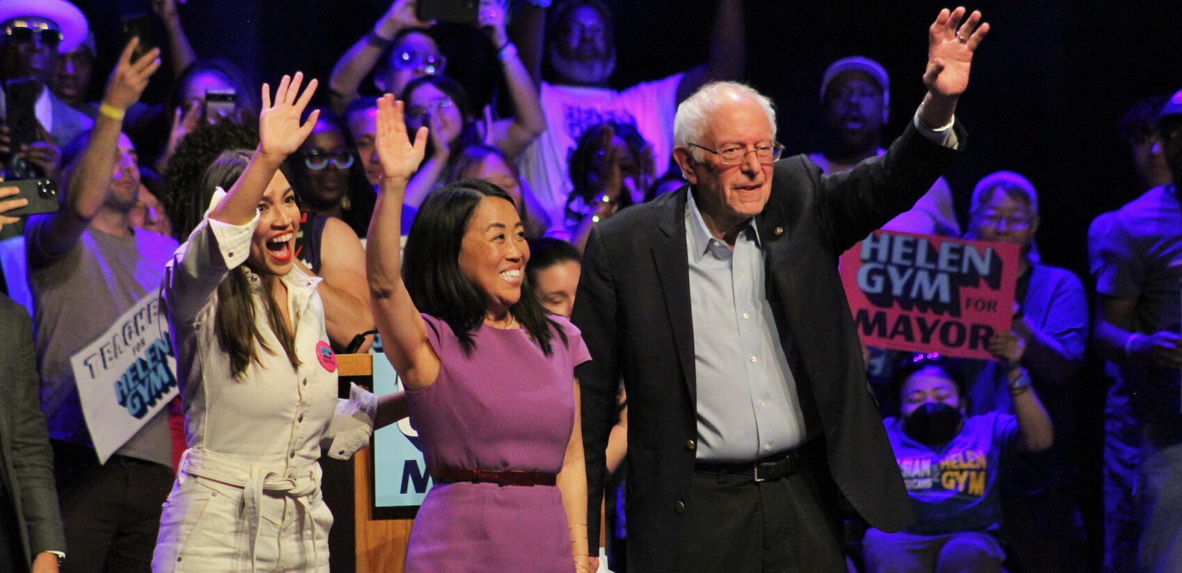 Helen Gym posing at a rally with Rep. Ocasio-Cortez and Sen. Sanders.