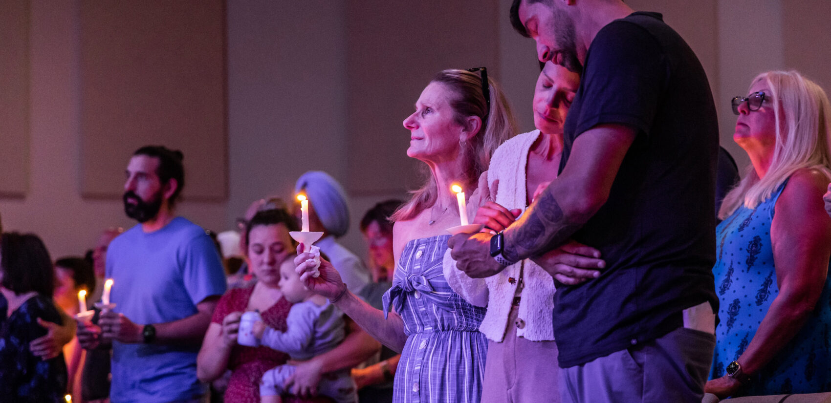 People gather at a candlelight vigil
