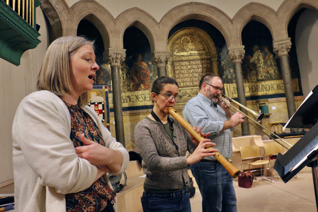 2023 12 05-e lee-clara rottsolk heloise degrugillier greg ingles-philadelphia episcopal cathedral-piffaro christmas concert rehearsal soprano Soprano Clara Rottsolk (left)sings with Heloise Degrugillier (tenor recorder) and Greg Ingles (tenor Sackbut) and other members of Piffaro The Renaissance Band. (Emma Lee/WHYY)