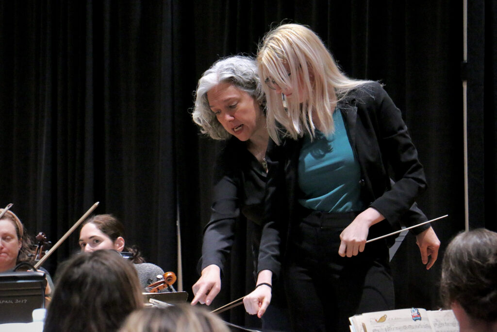 Philadelphia Ballet Orchestra Music Director Beatrice Jona Affron instructs apprentice conductor Amelia Krinke