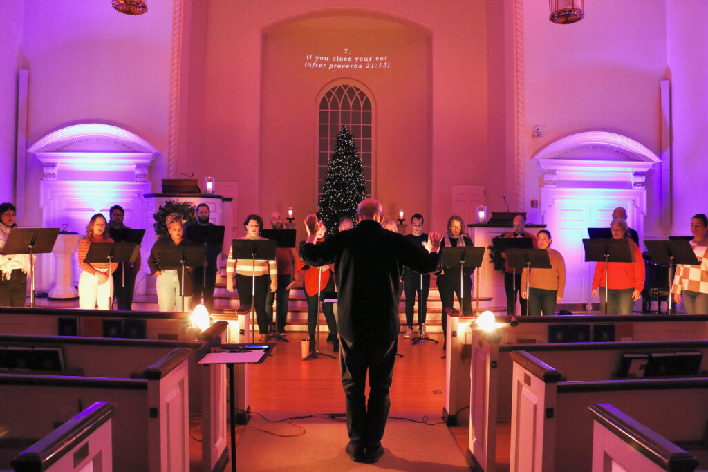 Donald Nally conducts members of The Crossing as they sing during a rehearsal.