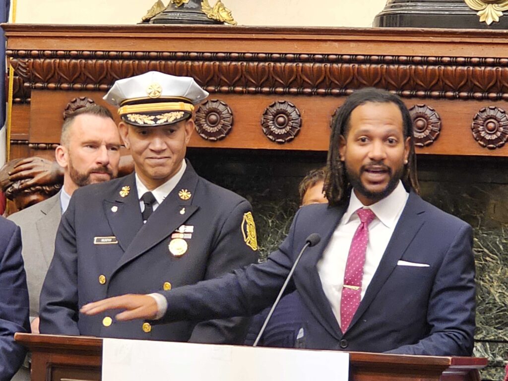 20231228_103733 Incoming Philadelphia Chief Public Safety Director Adam Geer (right) speaks at the appointment announcement for him and soon-to-be Acting Fire Commissioner Craig Murphy (left). (Tom MacDonald/WHYY)
