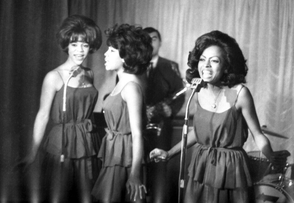 The Supremes, from left, Florence Ballard, Mary Wilson and Diana Ross, perform during a reception for them in a hotel, in London.