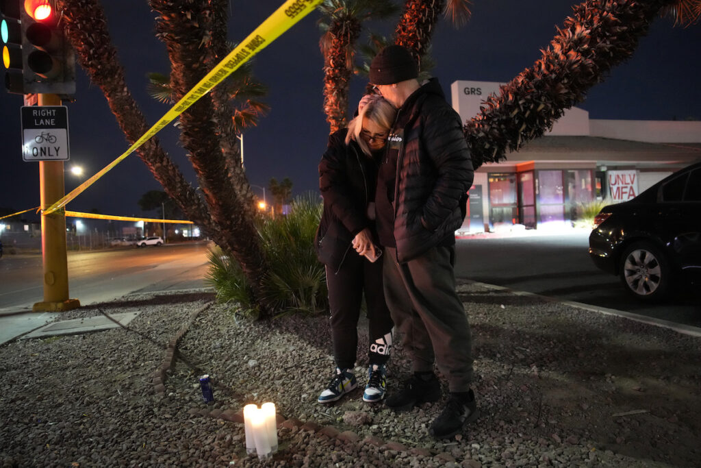 APTOPIX Campus Shooting Las Vegas Sean Hathcock, right, kisses Michelle Ashley after the two left candles for victims of a shooting at the University of Nevada, Las Vegas, Wednesday, Dec. 6, 2023, in Las Vegas. The two graduated from the school and live nearby. (AP Photo/John Locher)