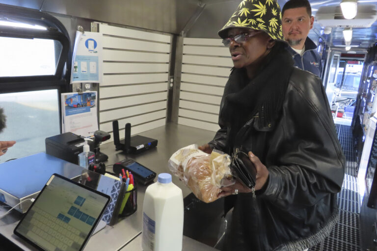 Delorese Butley-Whaley brings her purchases of milk and bread to the register