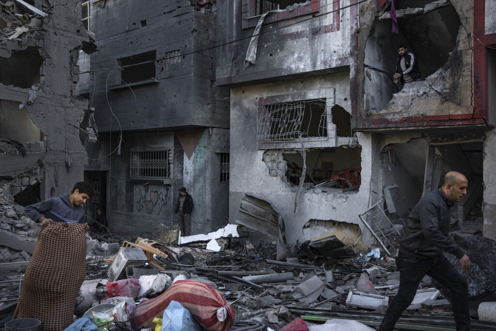 Israel Palestinians Palestinians look at houses destroyed in the Israeli bombardment of the Gaza Strip in Rafah on Saturday, Dec. 9, 2023.